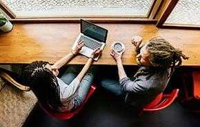 Young people in a coffee shop with a laptop computer